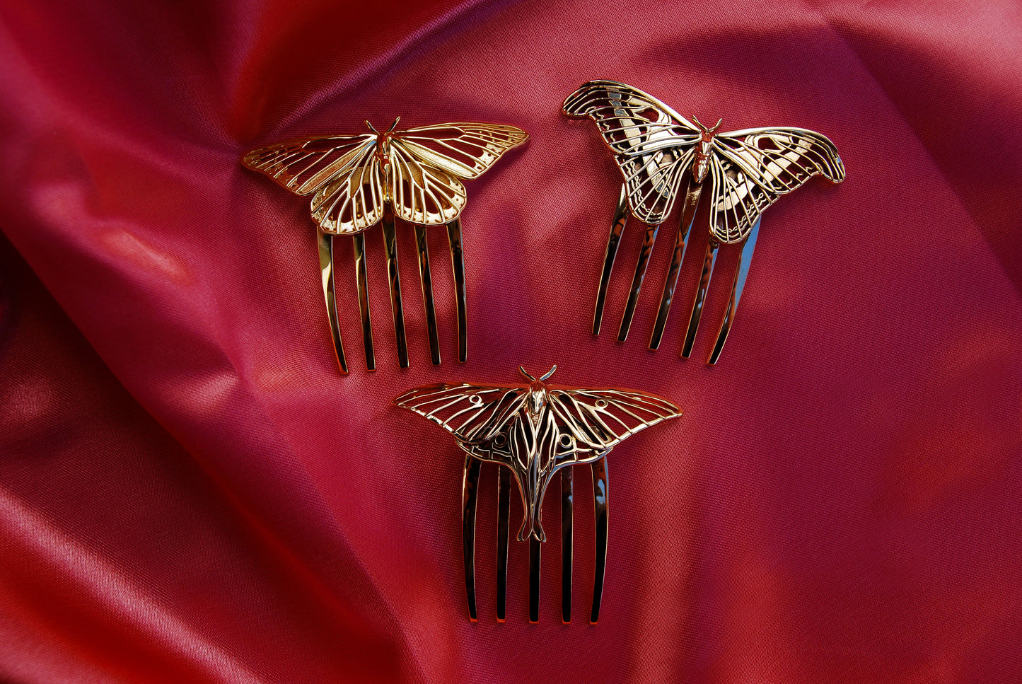 Monarch Butterfly hair comb in 14k gold plated brass, Luna Moth and Atlas Moth hair combs in polished bronze, displayed together to showcase handcrafted insect-inspired jewelry with intricate cut-out detailing and elegant finishes.