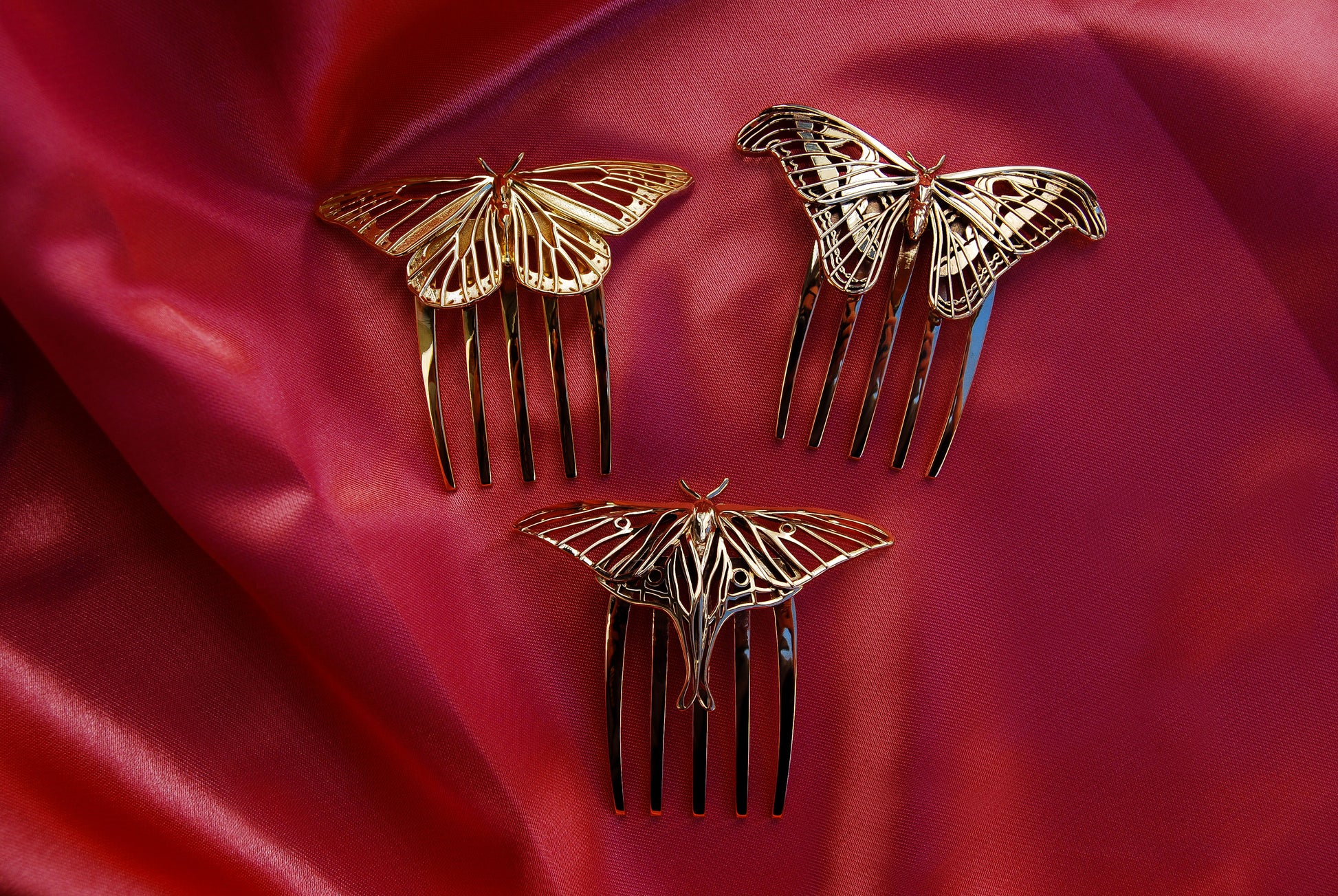 Monarch Butterfly hair comb in 14k gold plated brass, Luna Moth and Atlas Moth hair combs in polished bronze, displayed together to showcase handcrafted insect-inspired jewelry with intricate cut-out detailing and elegant finishes.