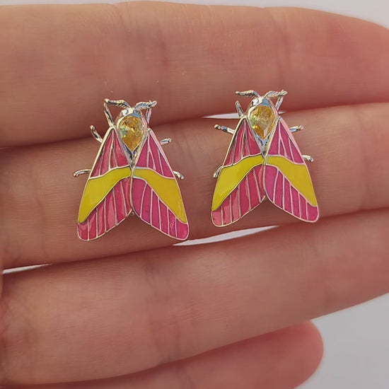 Video of Rosy Maple Moth earrings showing enamel details and gemstone sparkle