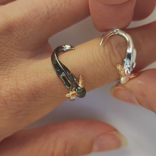 Step-by-step front view of wearing the handcrafted Axolotl stacking ring set — individual sterling silver and black rhodium axolotl rings with 14k rose gold gills are layered to gradually form a heart shape with their intertwined tails