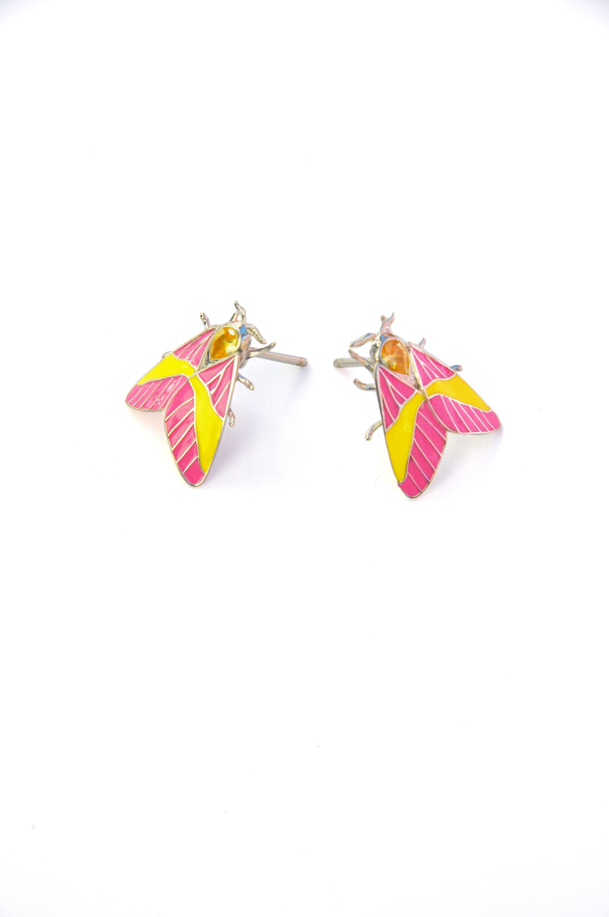 Rosy Maple Moth earrings laid horizontally on white background showing wing and crystal details
