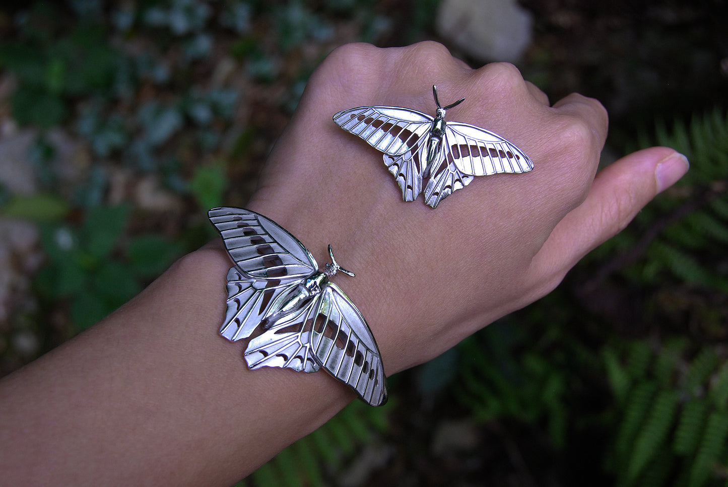 
Blue Triangle Butterfly pendant and bracelet set in nature, emphasizing eco-friendly insect jewelry and artisanal detail.
