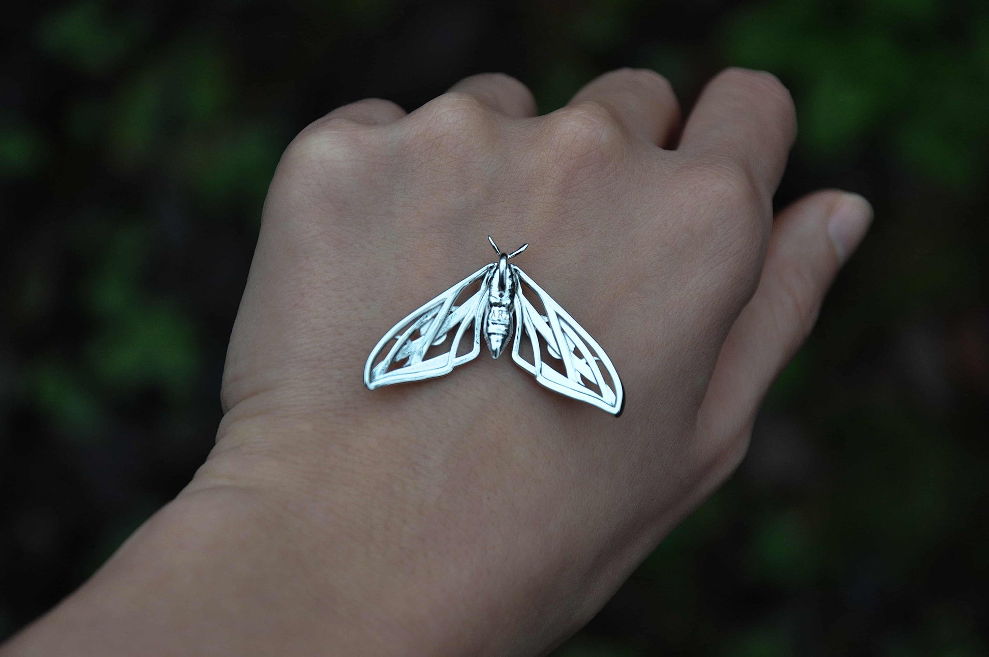Back view of the sterling silver Hawk Moth Pendant, revealing smooth contours and hand-polished finish.