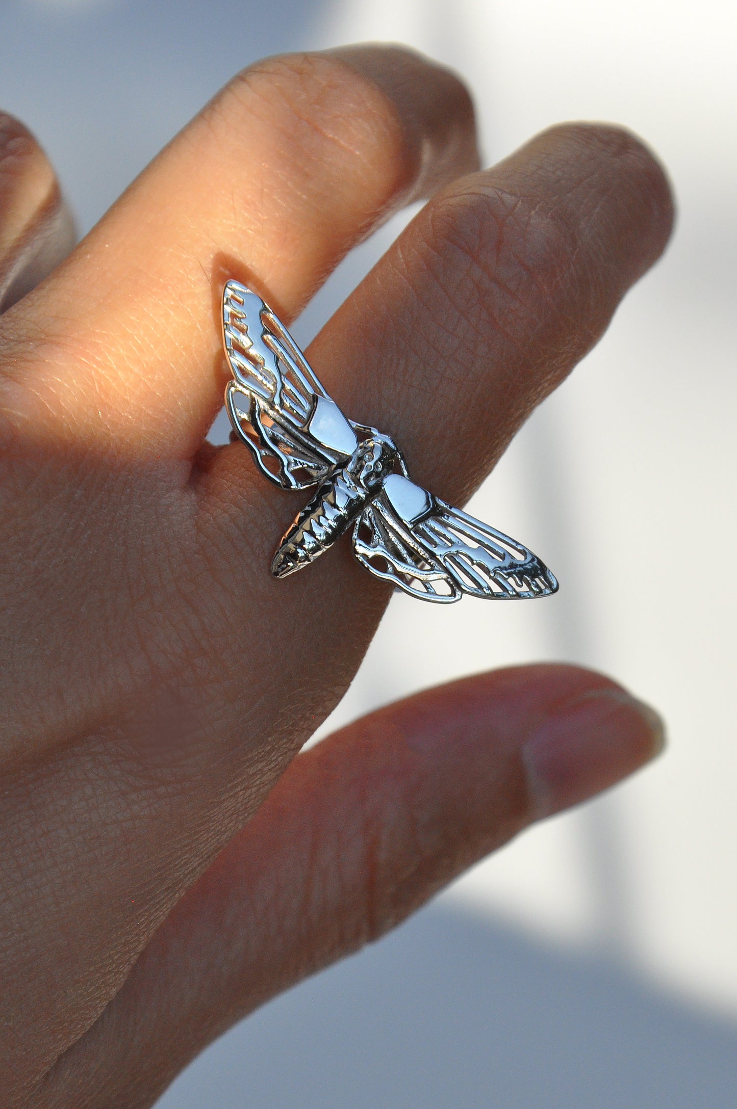 Close-up of the silver Death’s-Head Hawk Moth Ring being worn, highlighting texture and craftsmanship