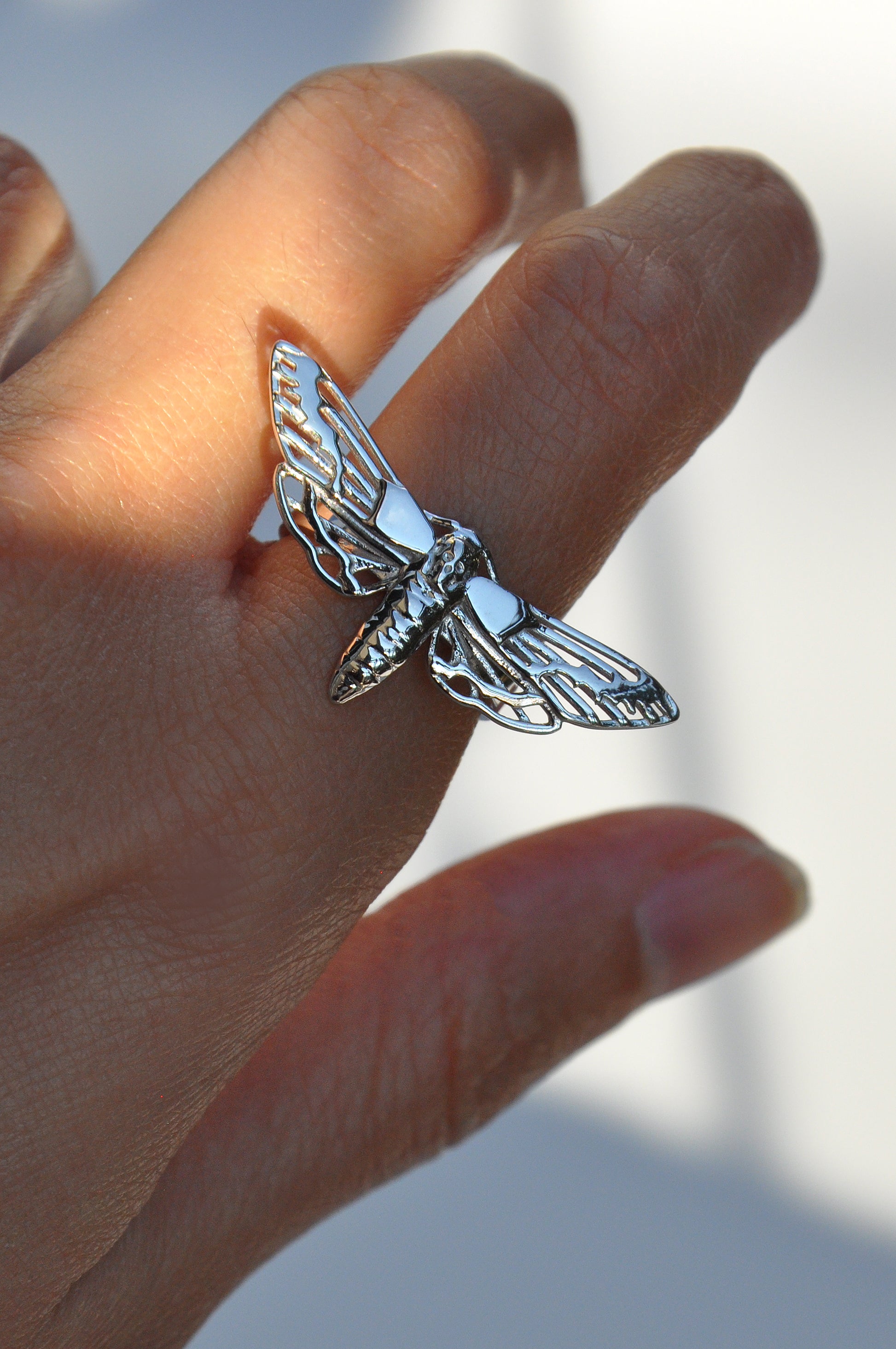 Close-up of the silver Death’s-Head Hawk Moth Ring being worn, highlighting texture and craftsmanship
