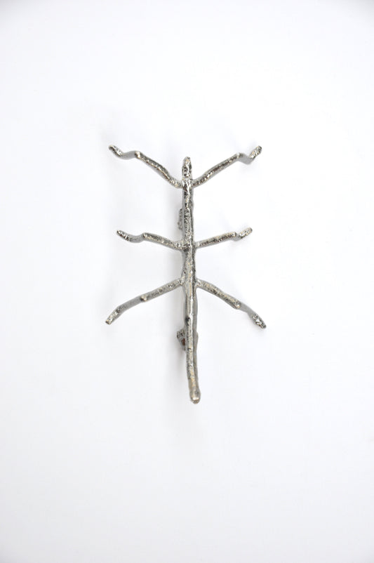  Front view of the silver stick insect brooch on a white background, showing intricate detail and texture.
