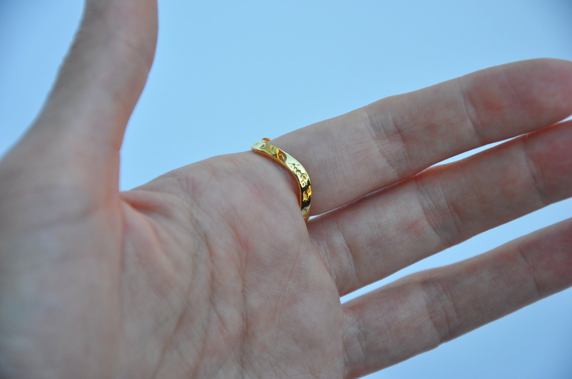 Back view of celestial snake ring on model, highlighting wrap-around design and smooth finish.