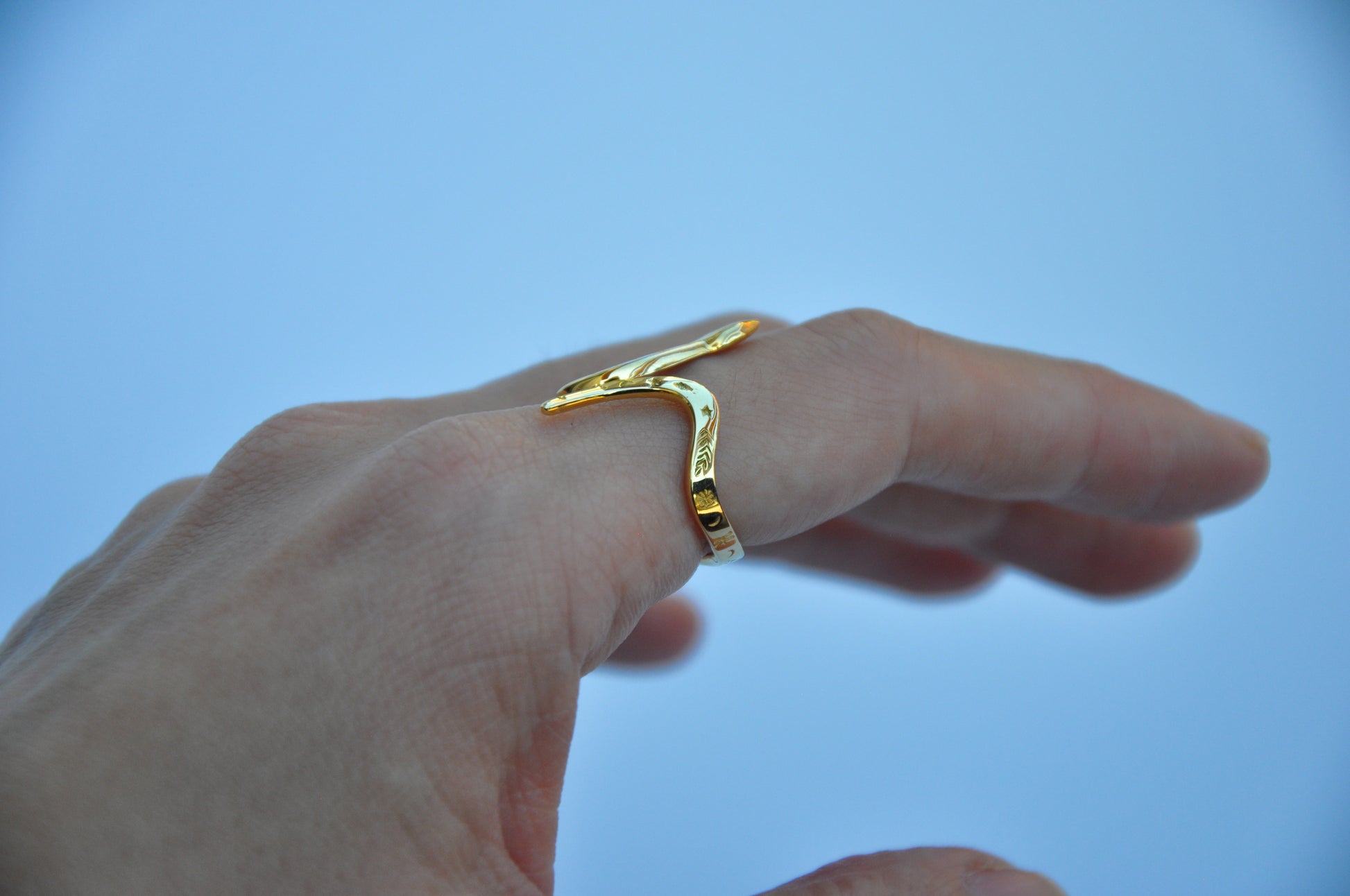 Side view of celestial snake ring on model’s hand, emphasizing band width and snake silhouette.