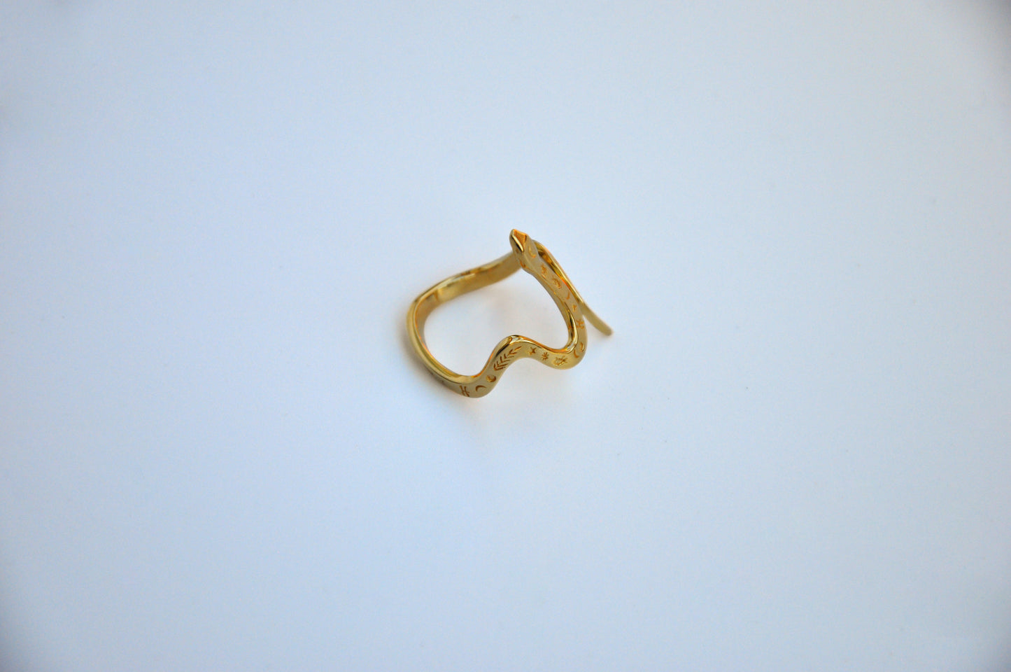 Side view of celestial snake ring in 14K gold plated finish on white background, highlighting polished band and serpent detail.