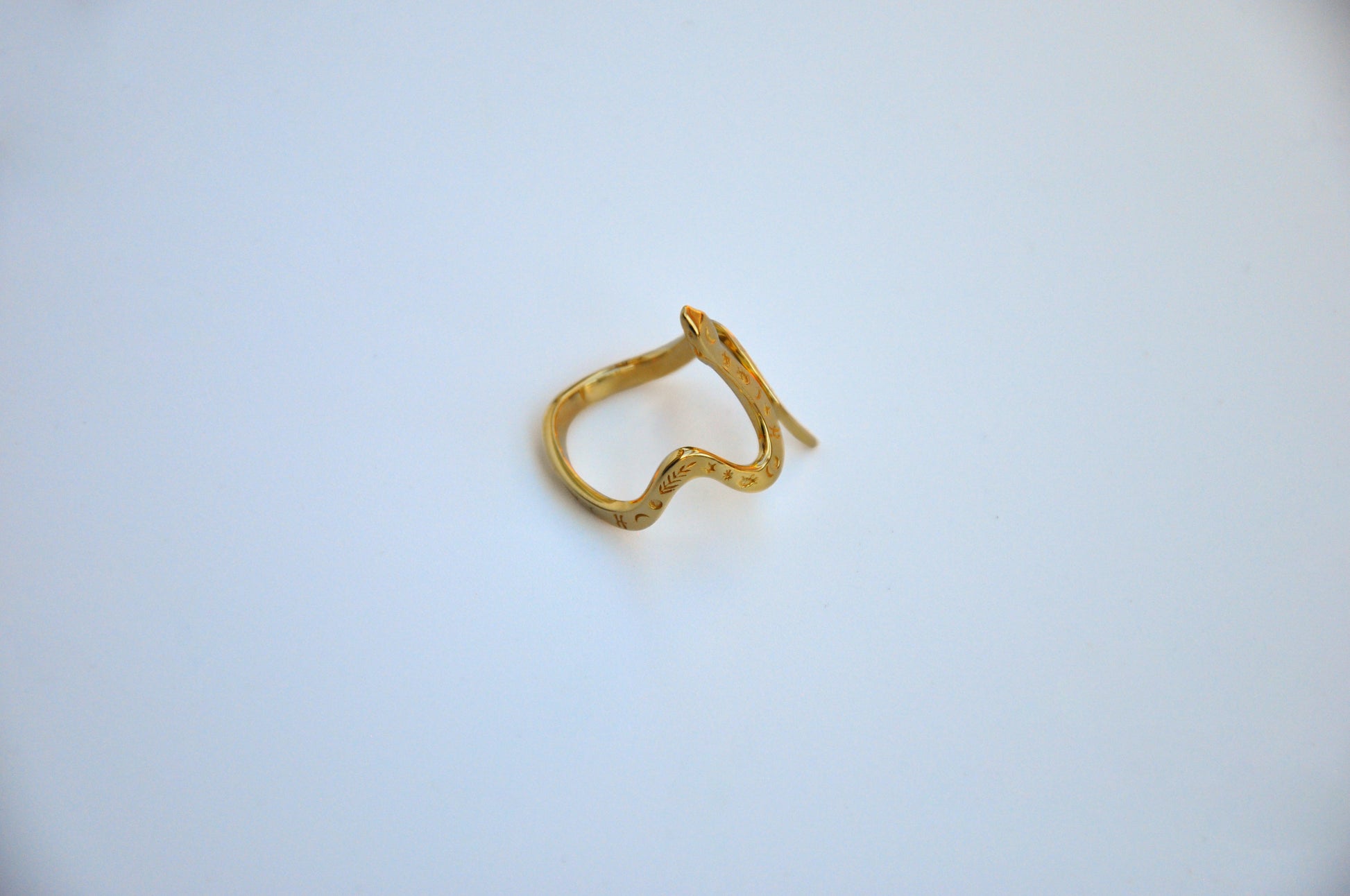 Side view of celestial snake ring in 14K gold plated finish on white background, highlighting polished band and serpent detail.