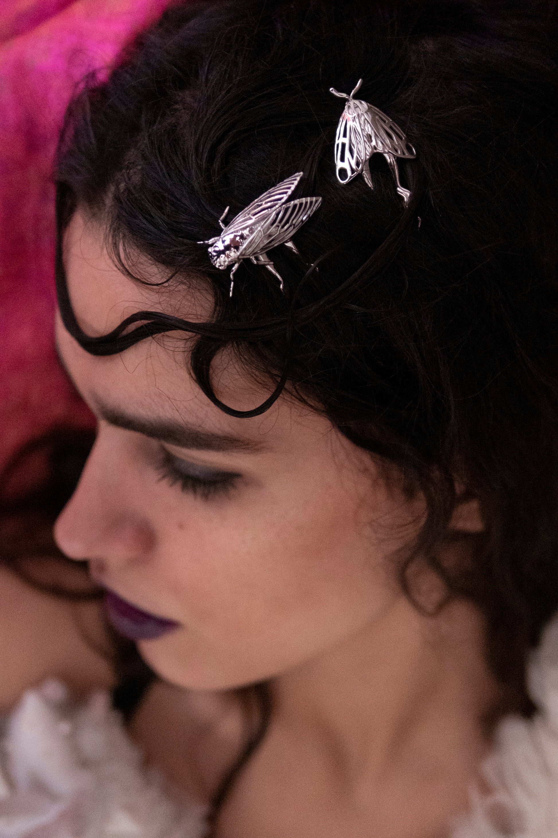 Model wearing silver Tiger Moth and Cicada hair pins styled in an elegant updo, showcasing handcrafted insect-inspired jewelry with detailed wing designs and a polished metallic finish.