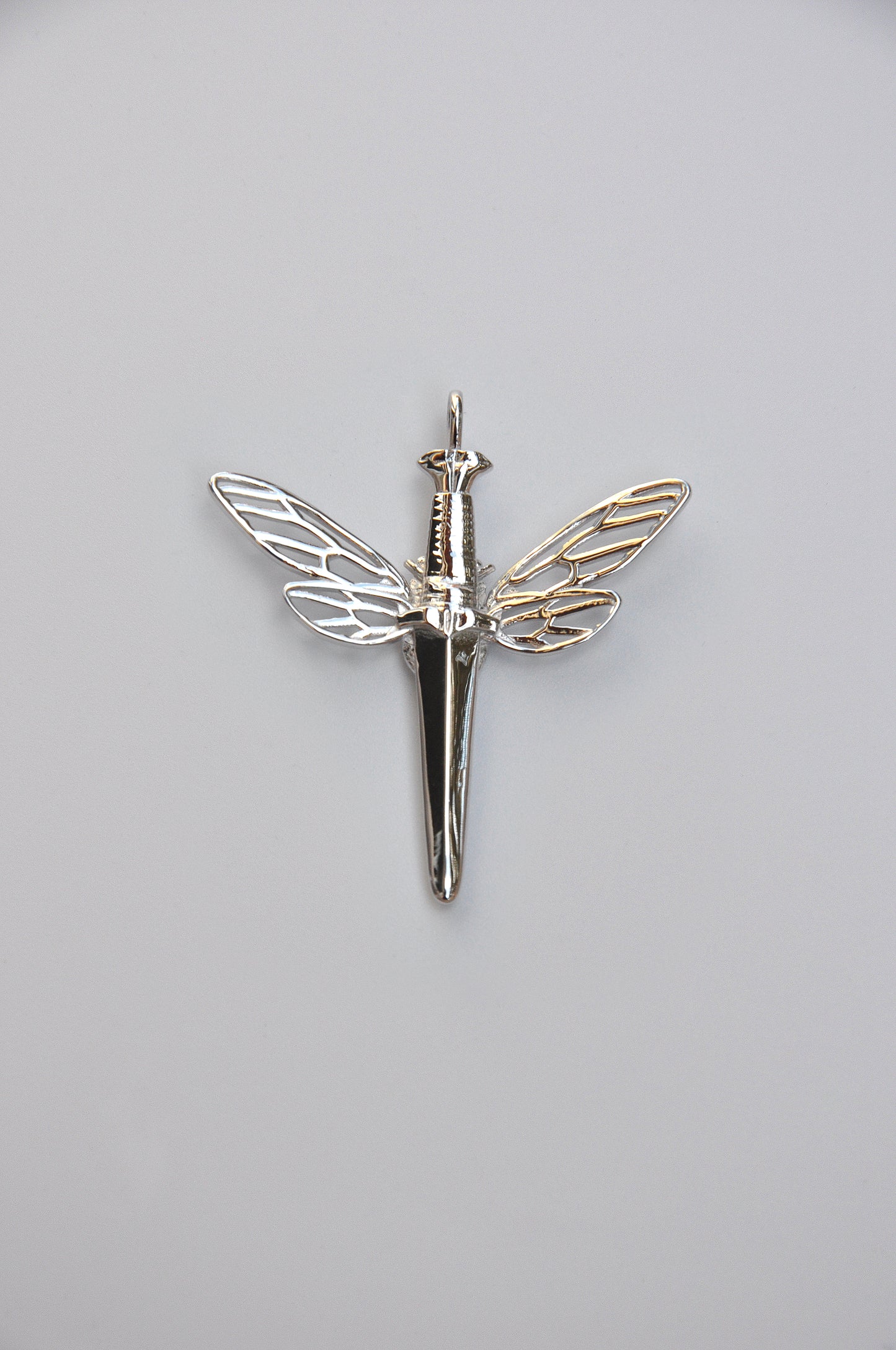 Symbolic cicada dagger pendant in 925 sterling silver with luminous white stone, blending nature and strength.