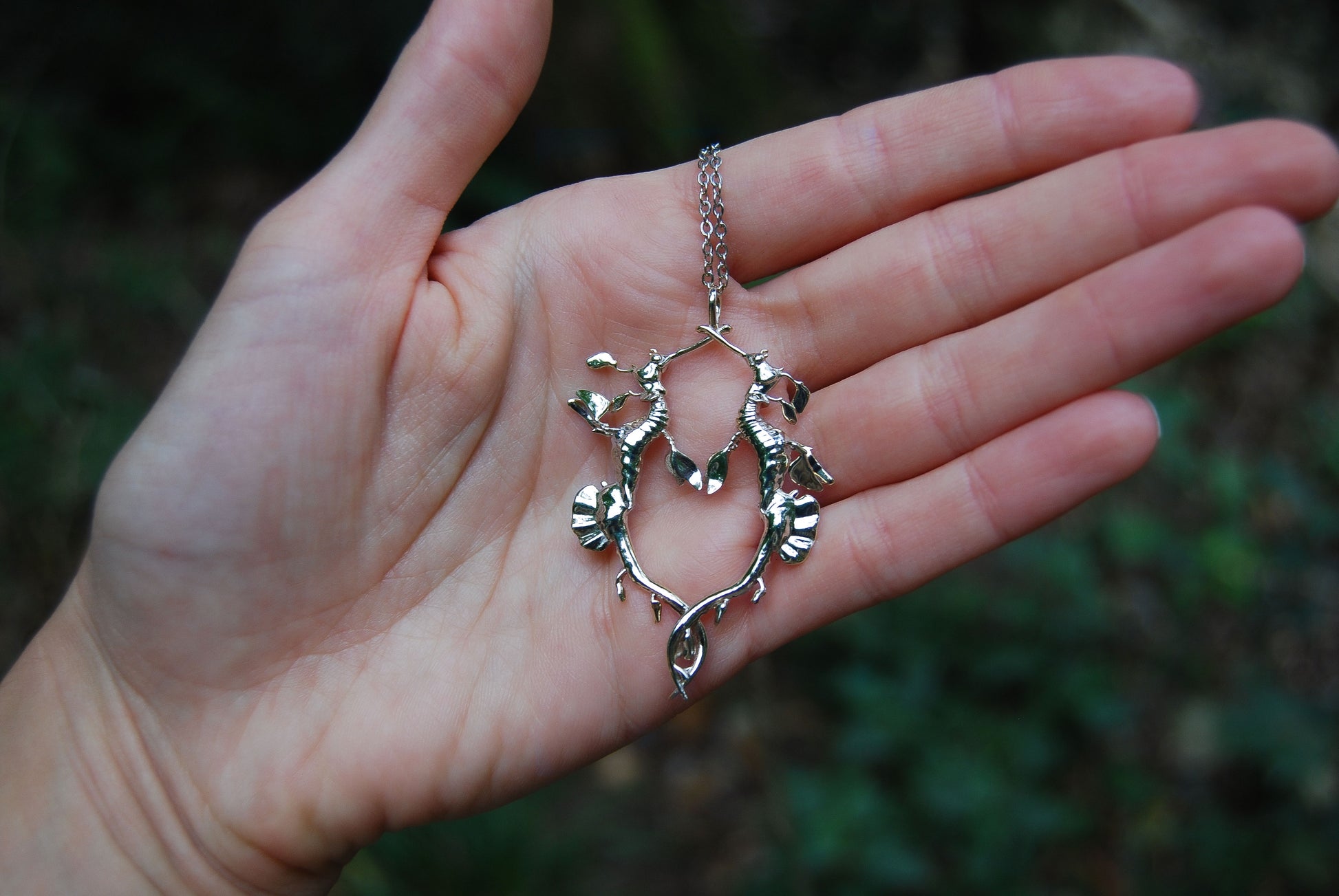 Gold Weedy Sea Dragon Pendant styled on hand, elegant marine life jewelry with romantic detail.