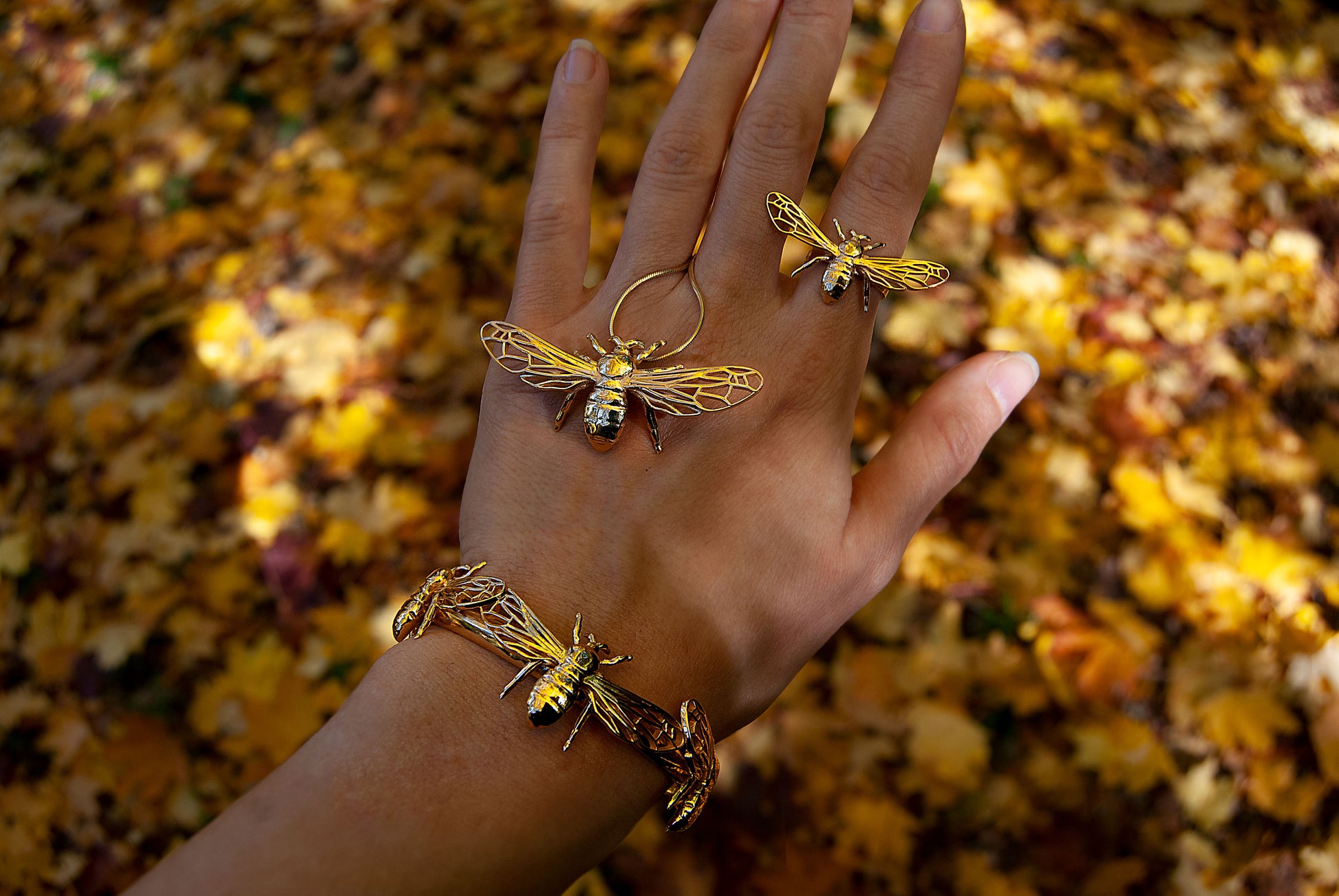 Gold bee bracelet cuff worn on hand