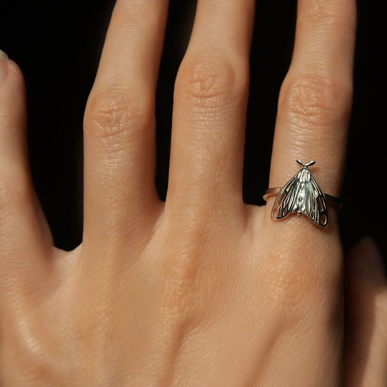 Alternate view of silver Tiger Moth Ring on finger, emphasizing sculptural insect jewelry.